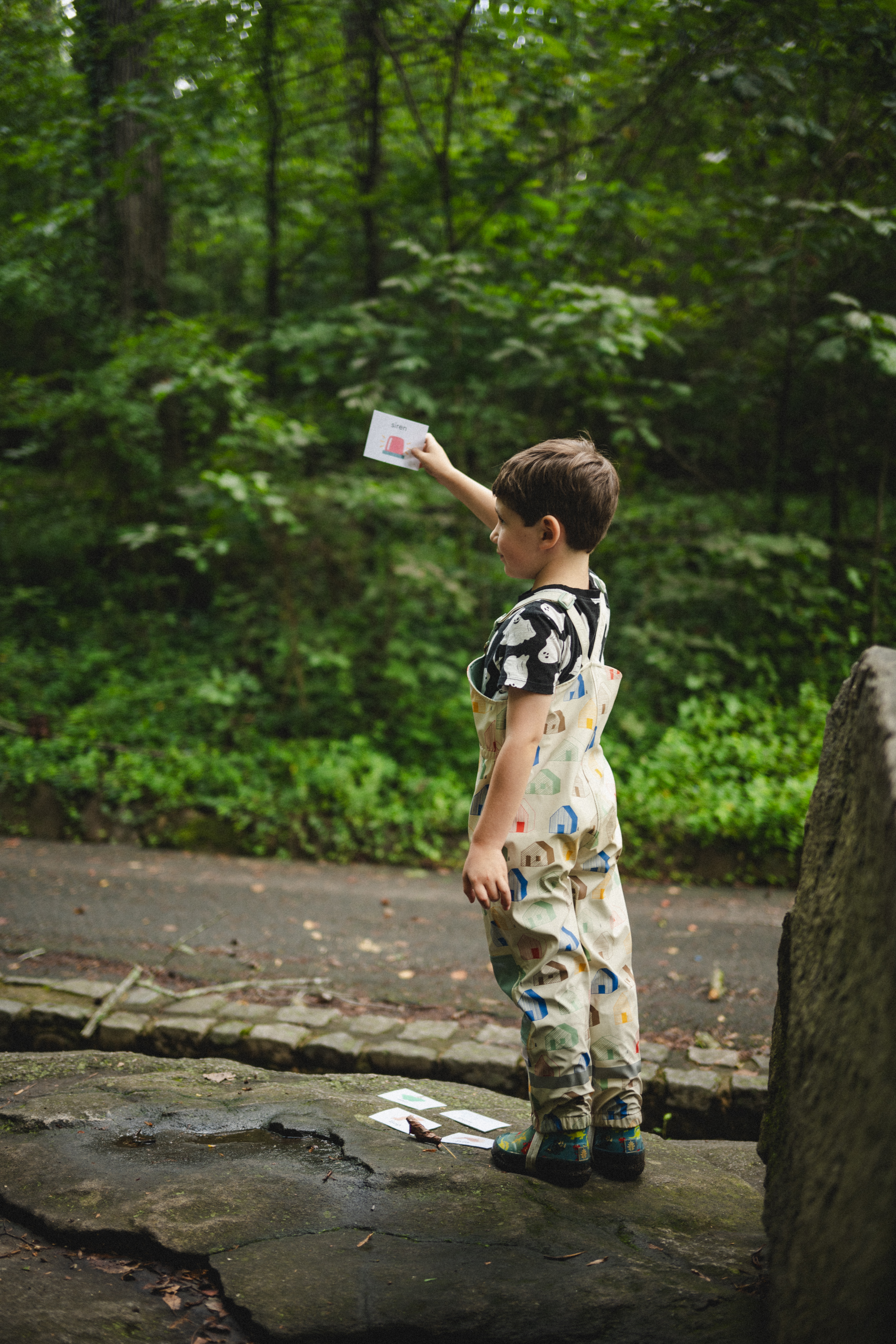 child holding up siren sound card